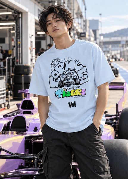 TIGERS Formula Racing Blue T-Shirt worn by a model at a racetrack with a racing car in the background.