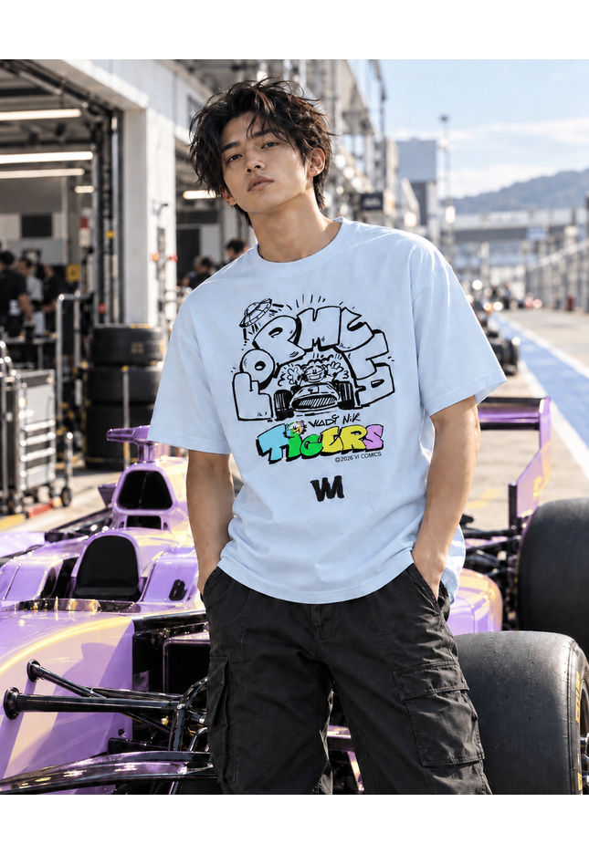 TIGERS Formula Racing Blue T-Shirt worn by a model at a racetrack with a racing car in the background.