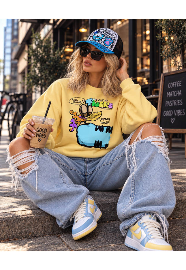 Woman wearing TIGERS™ Blue Tiger sweatshirt from the VI COMICS™ Fall Collection with a TIGERS cap and streetwear outfit